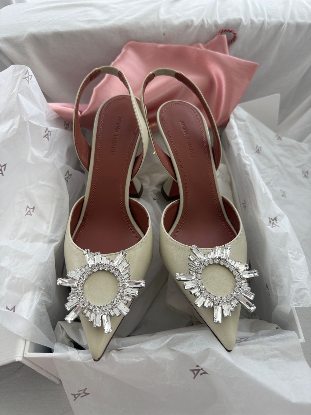 Amina Muaddi Ivory Pointed Slingback Heels with Crystal Sunburst